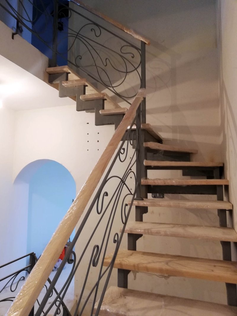 Забежные ступени поворотной лестницы с ограждением в стиле модерн, вид снизу