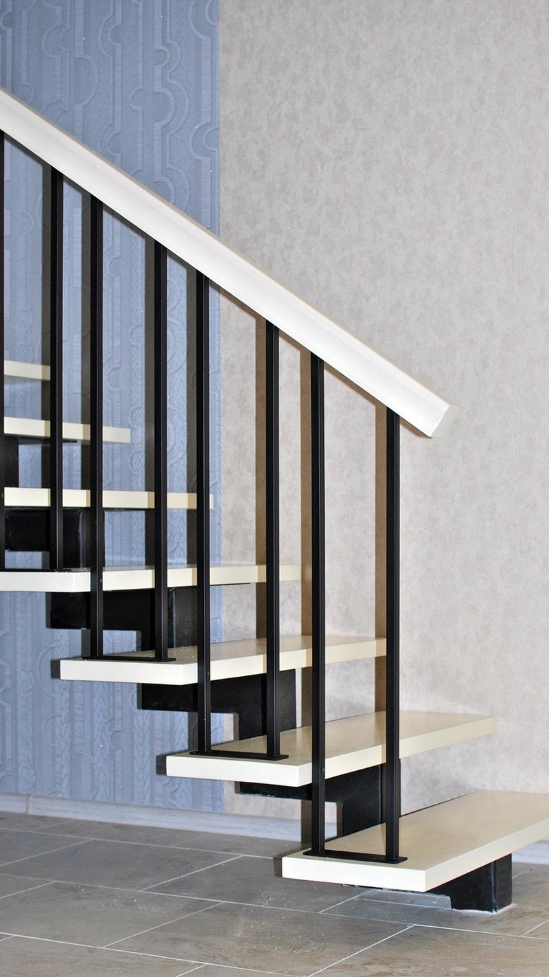 Ограждение для лестницы на одном косоуре черного цвета с белым поручнем, вид снизу сбоку